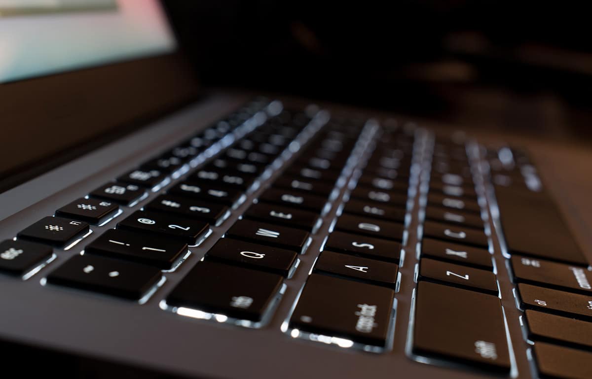 illuminated computer keyboard in the dark. selective focus